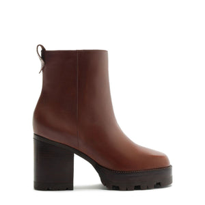 Side view of 240 Leather Bootie in Warm Toffee showcasing its block heel and lug sole with a white background
