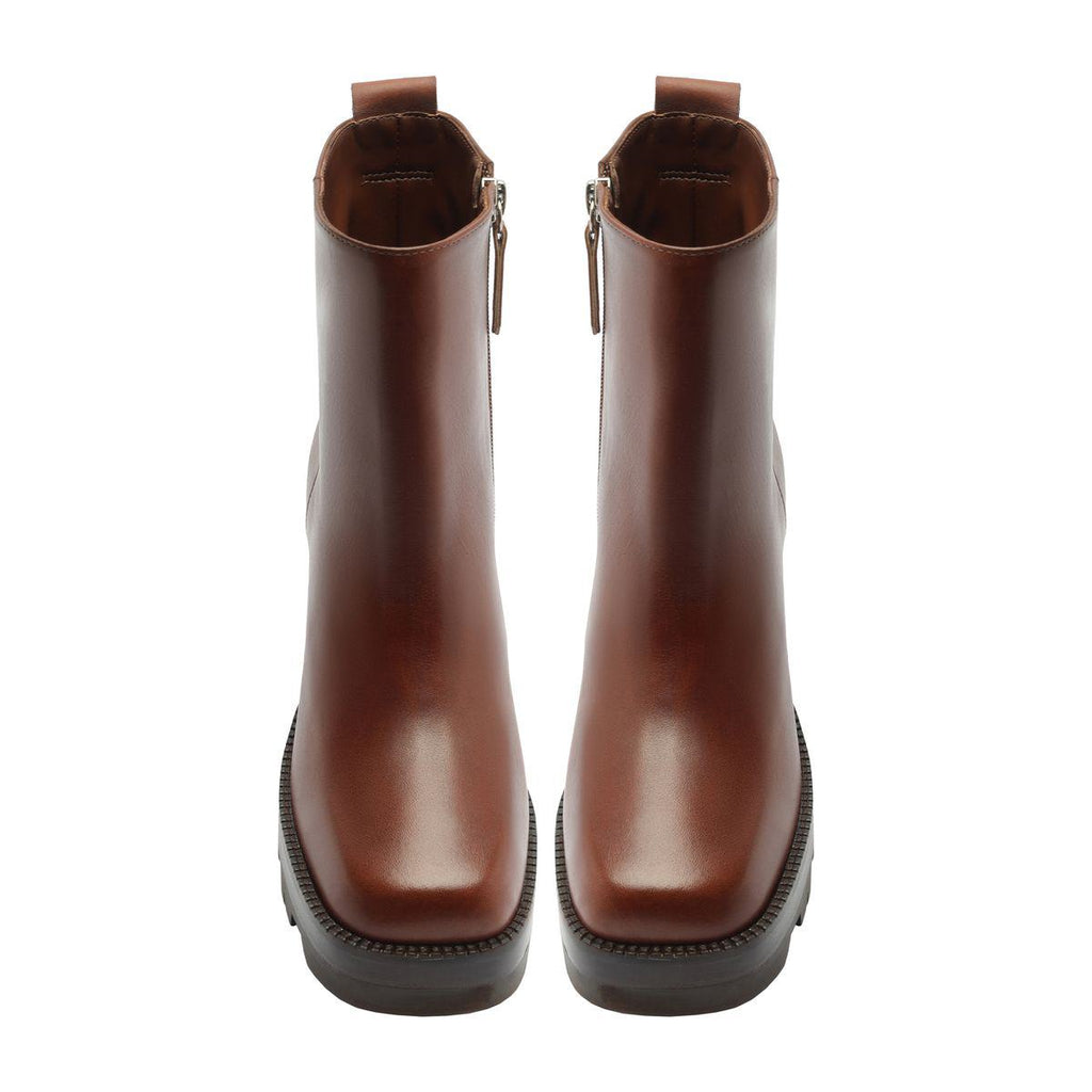 Front view of 240 leather booties in warm toffee showcasing rounded toes and ankle-height shafts on a white background