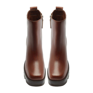 Front view of 240 leather booties in warm toffee showcasing rounded toes and ankle-height shafts on a white background