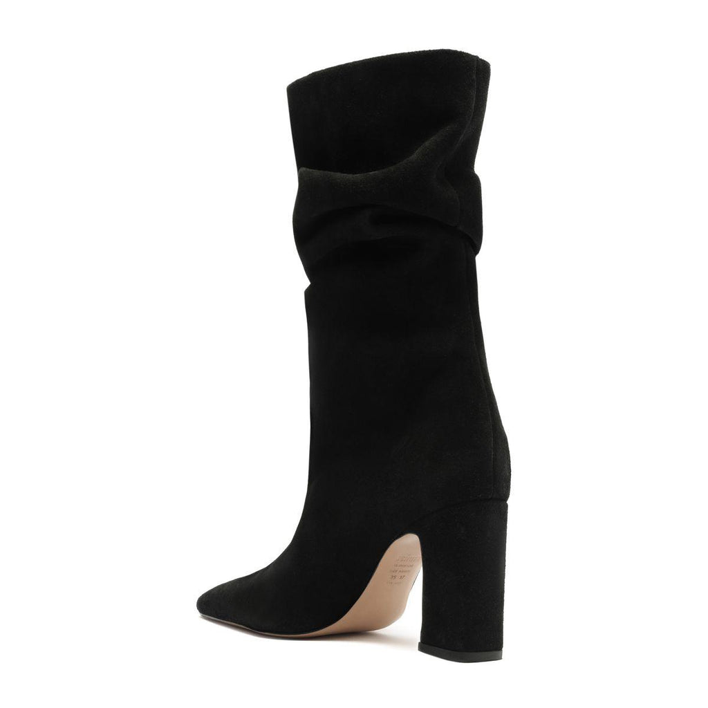 Side view of Harriet suede boot in black showcasing its tall slouchy shaft and high heel against a white background