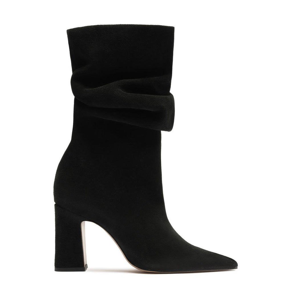 Side view of Harriet suede boot in black showcasing a sculptural folded cuff, pointed toe, and tall block heel with a white background