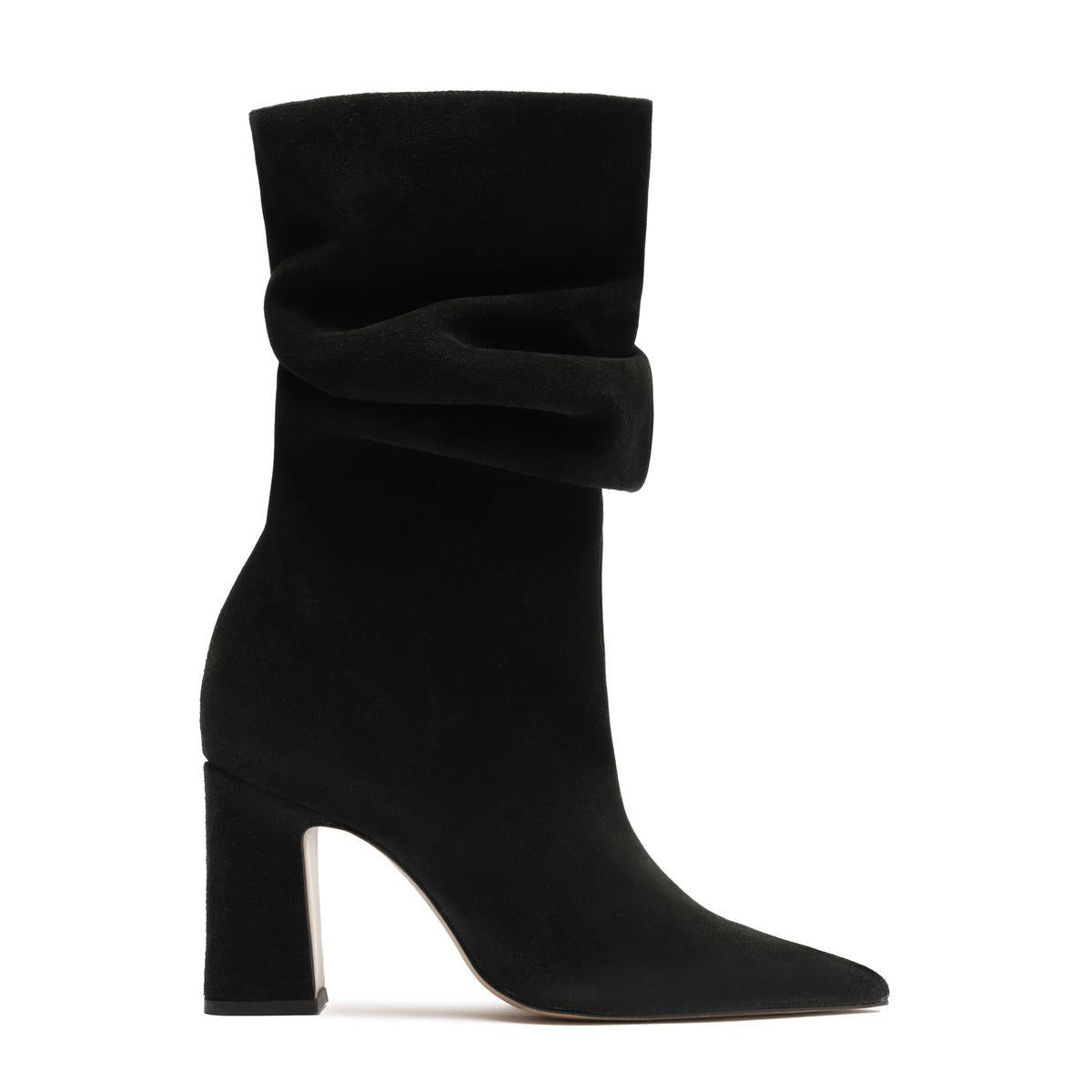 Side view of Harriet suede boot in black showcasing a sculptural folded cuff, pointed toe, and tall block heel with a white background