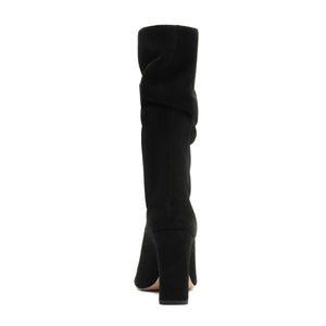 Rear view of Harriet suede boot in black showcasing its tall shaft and heel with a white background