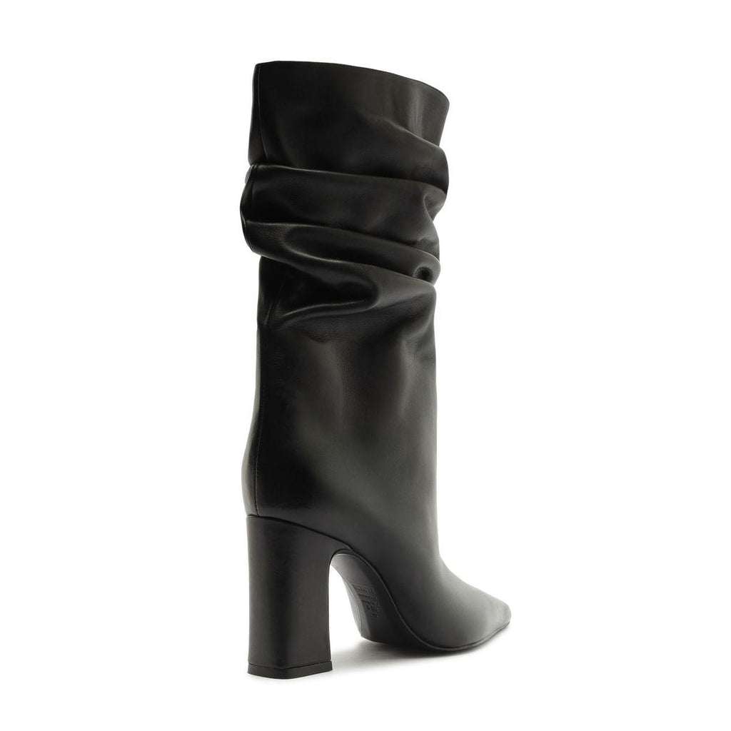 Side view of Harriet leather boot in black showcasing a ruched shaft and block heel on a white background
