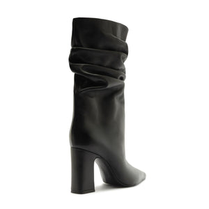 Side view of Harriet leather boot in black showcasing a ruched shaft and block heel on a white background