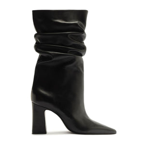 Side view of Harriet leather boot in black showcasing its ruched shaft, pointed toe, and high block heel with a white background