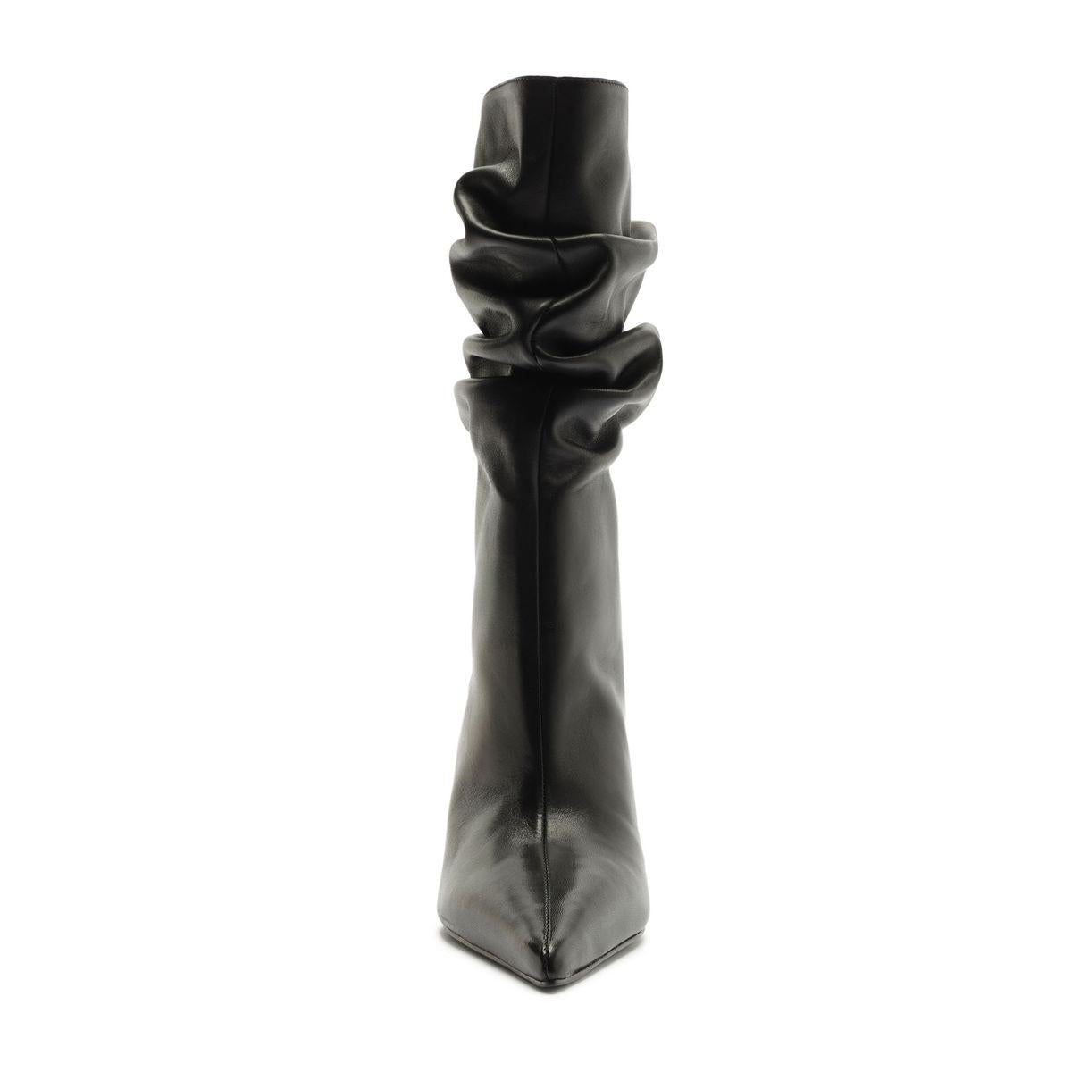 Front view of Harriet leather boot in black showcasing its slouchy shaft and pointed toe with a white background