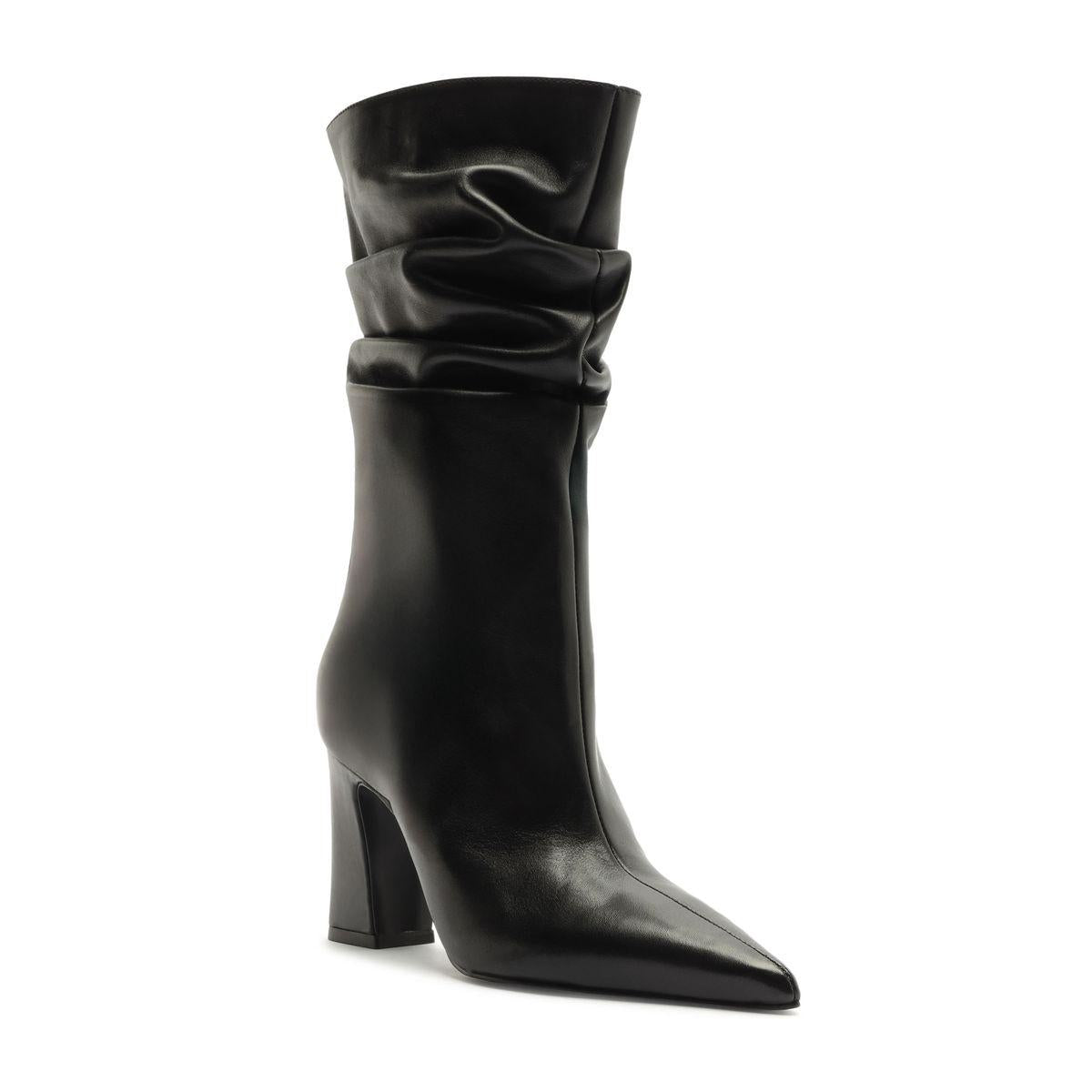 Three-quarter view of the Harriet Leather Boot in black showcasing its ruched shaft, pointed toe, and block heel on a white background