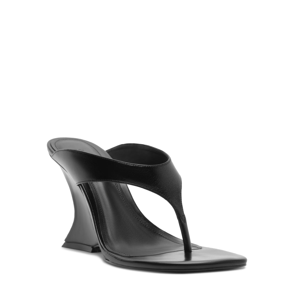 Three-quarter front view of Maya Leather Sandal in black showcasing sculpted wedge heel, thong-style upper and square toe on white background