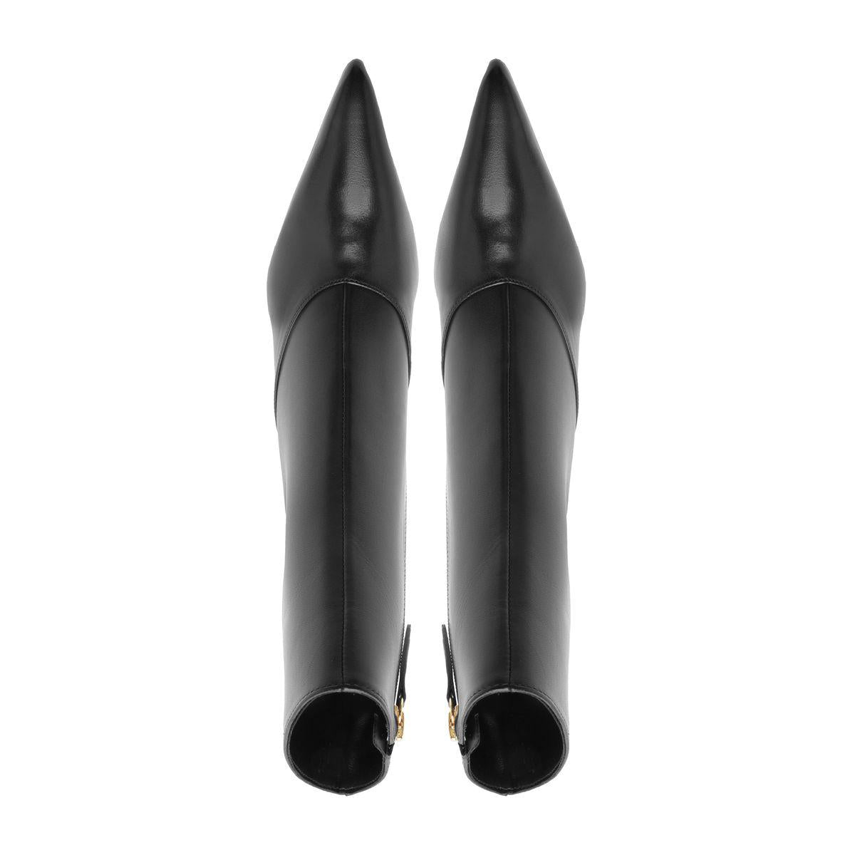 Rear view of Schutz Lexi Mid Leather Bootie in Black showcasing pointed toes and tall shafts against a white background