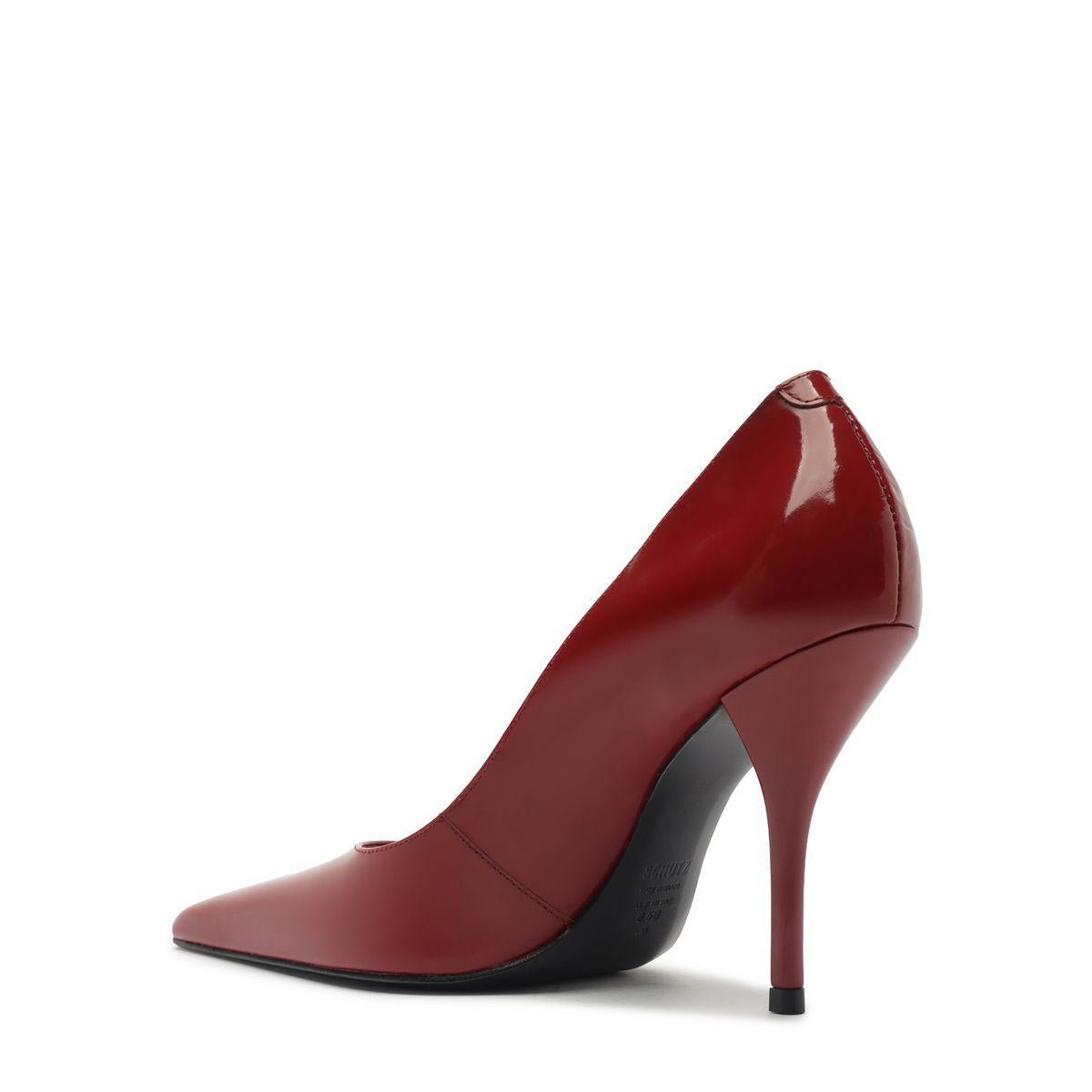 Side view of Miranda patent pump in Passion Red showcasing pointed toe and stiletto heel with a white background
