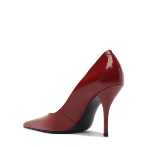 Side view of Miranda patent pump in Passion Red showcasing pointed toe and stiletto heel with a white background