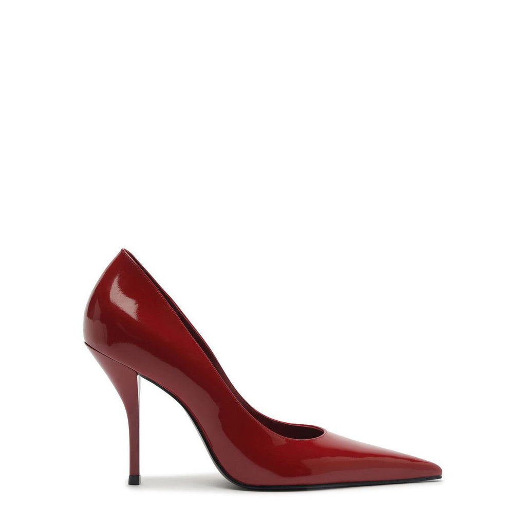 Side view of Miranda patent pump in passion red showcasing pointed toe and stiletto heel with white background