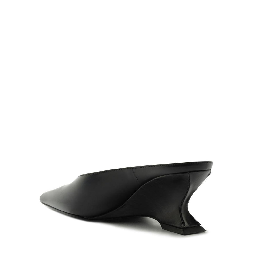 Side view of Siena Mid Mule Pump in black showcasing a pointed toe and sculptural heel on a white background