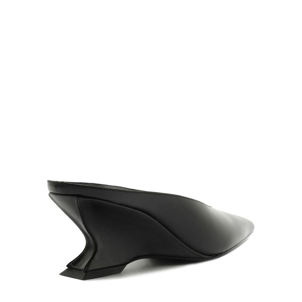 Side view of Siena Mid Mule Pump in black showcasing sculptural mid heel with a white background