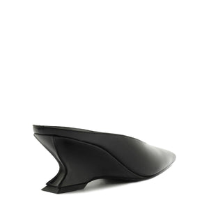 Side view of Siena Mid Mule Pump in black showcasing sculptural mid heel with a white background