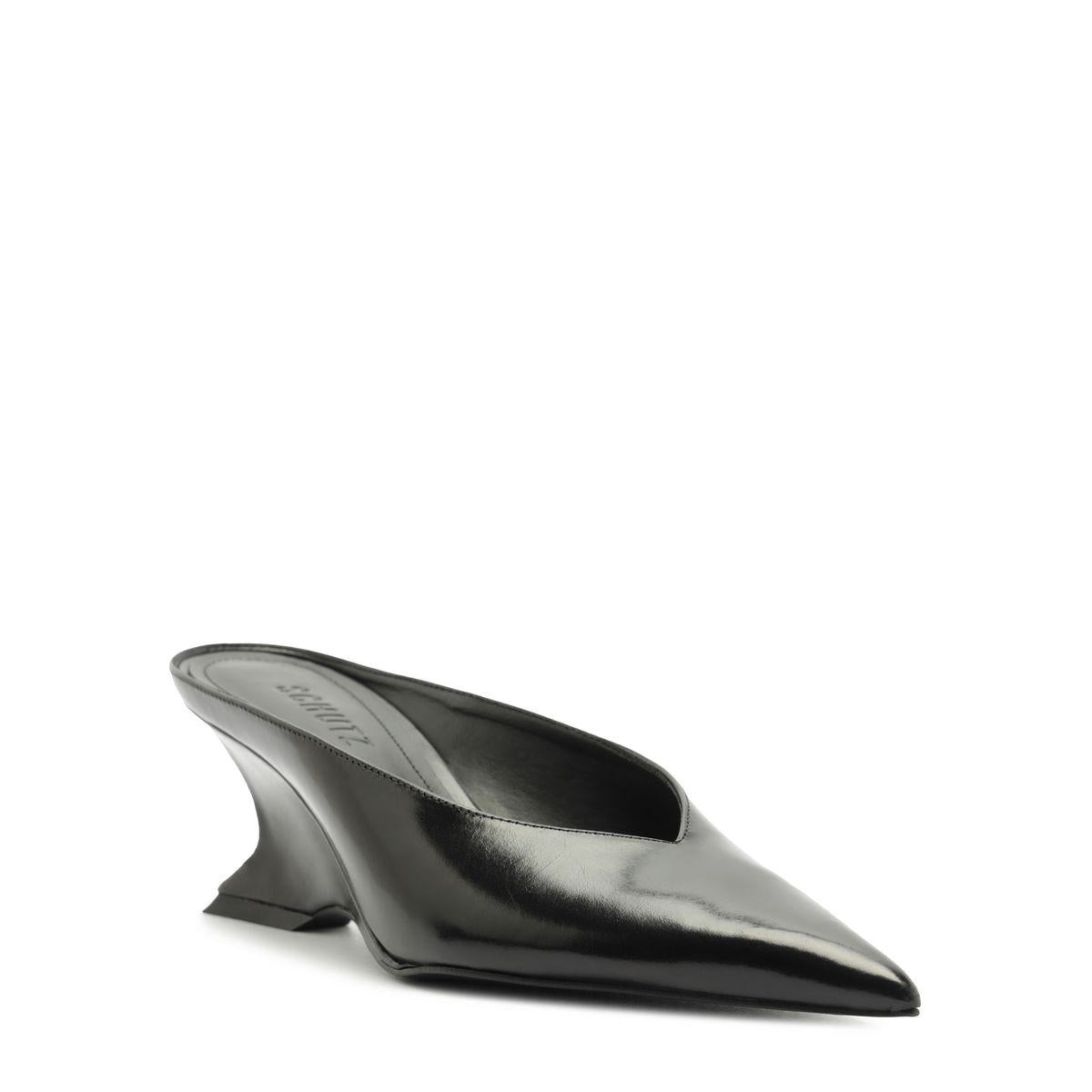 Side view of Siena mid mule pump in black showcasing its pointed toe and sculptural heel on a white background