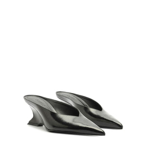 Side view of black Siena mid mule pumps showcasing pointed toes and sculptural heels on a white background