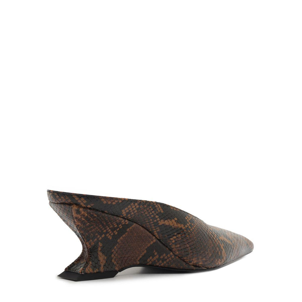 Side view of Siena mid mule pump in animal print showcasing its sculptural heel on a white background