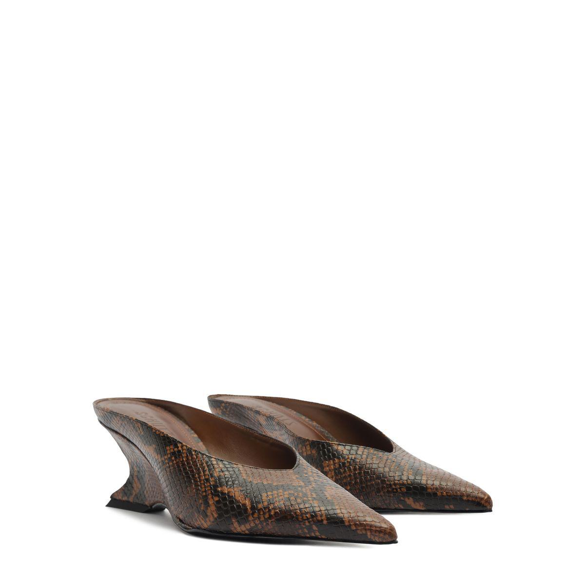 Three-quarter view of Siena mid mule pumps showcasing pointed toes and sculptural heels with a white background