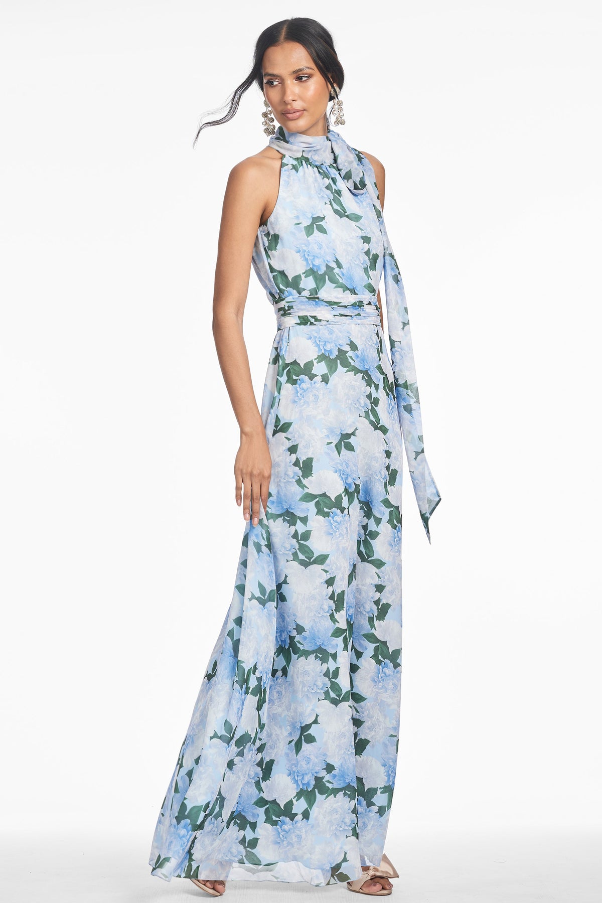 Front view of Kayla Gown in Glacial Peonies with floral maxi length, self tie neckline, and pleated waistband on model