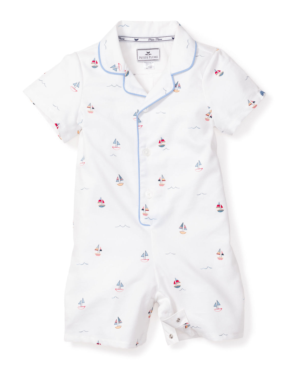 Flat lay of Baby’s Twill Summer Romper in Bateau with sailboat print, blue piped collar, short sleeves, front buttons and snap crotch