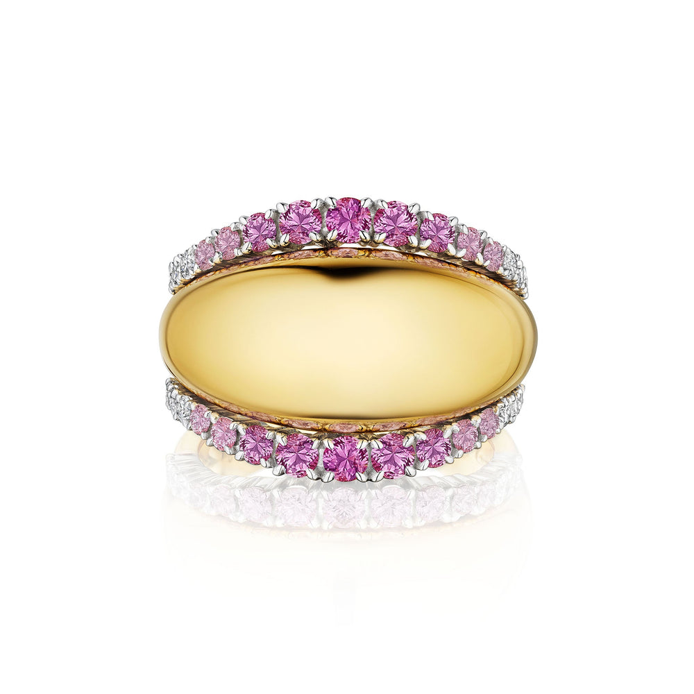 The Pink Coil Dome Ring with Pavé Sapphire Diamond Borders in Yellow Gold is shown on a white background, showcasing its wide dome shape in 18k yellow gold and two rows of pavé pink sapphires elegantly set along the edges.