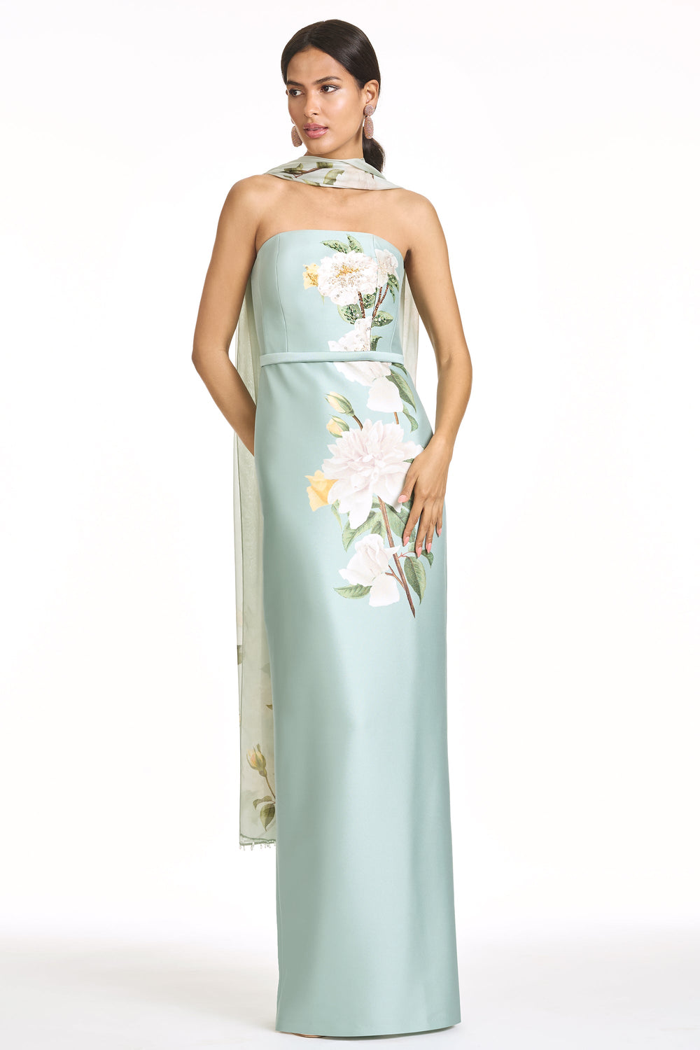 Three-quarter view of Embellished Sophia gown in celadon floral, strapless column silhouette with belt and attached sheer floral scarf