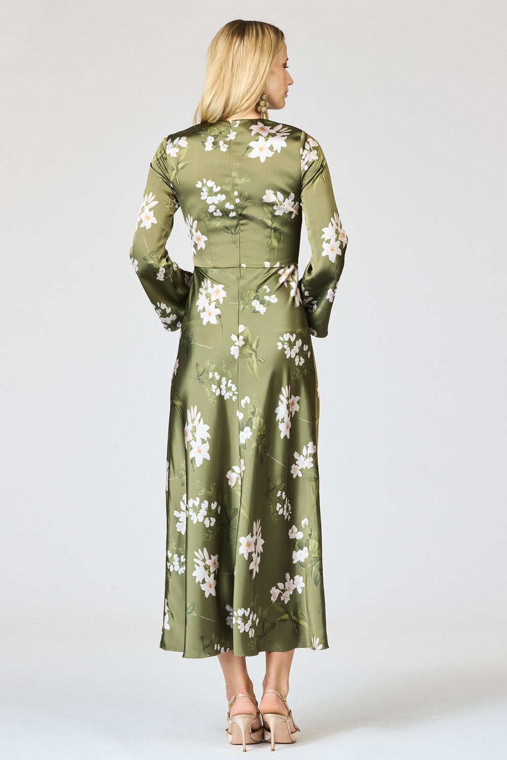 Back view of Tyra Dress in Moss Formosa showcasing long sleeves, fitted waist and midi skirt on light studio backdrop