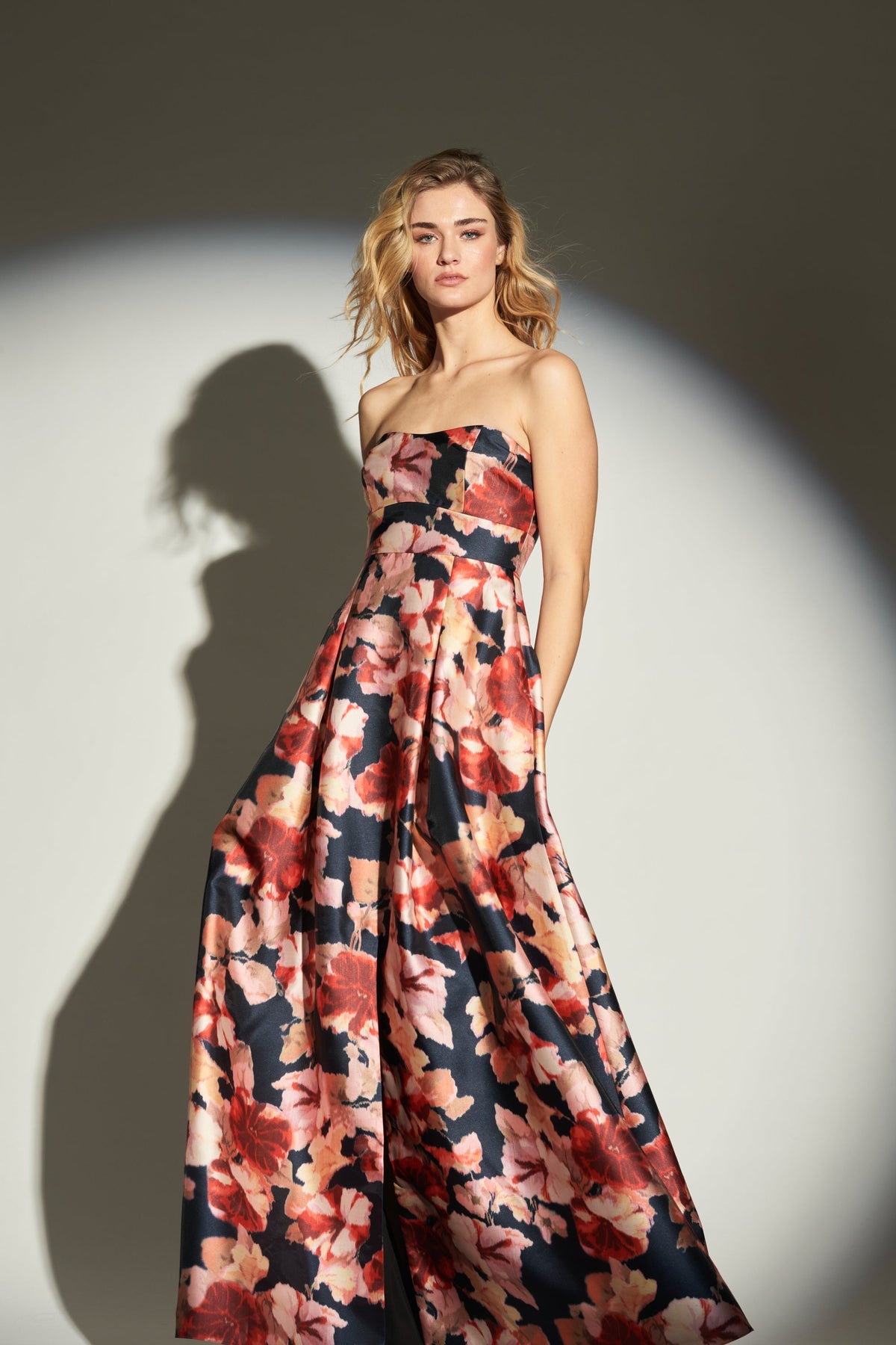 Front view of Embellished Giovanna Gown in Bedford Bouquet showcasing ikat florals and sweetheart neckline on gray backdrop