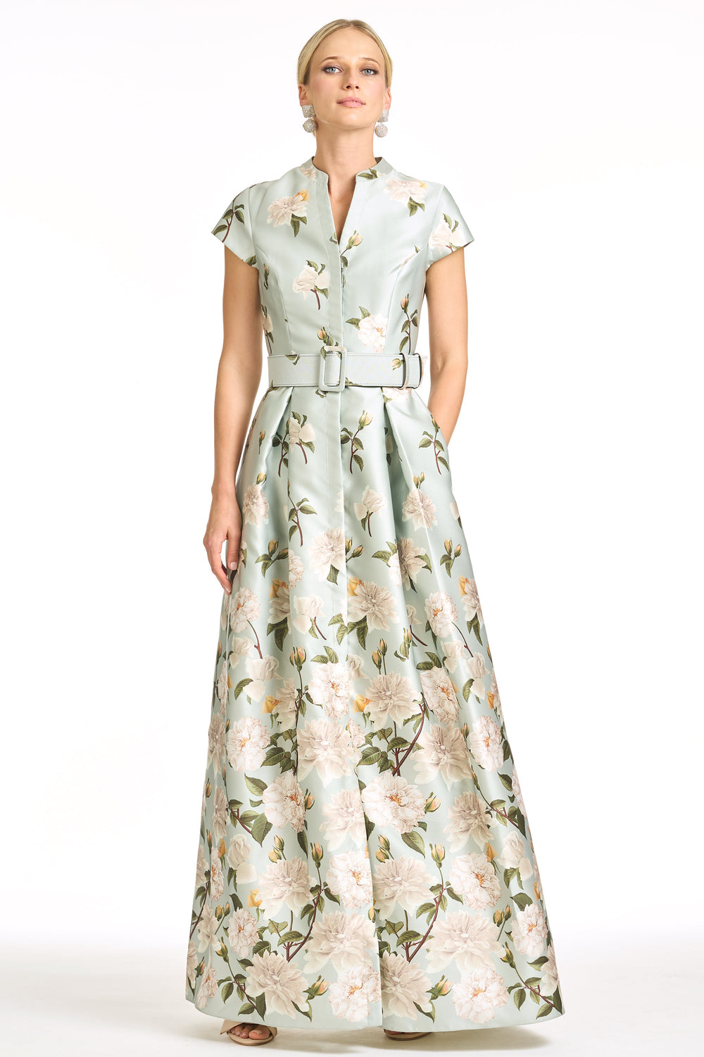 Front view of Marta Gown in Celadon Sweetbriar Degrade showcasing fitted bodice, belted waist, cap sleeves, and full floral skirt on white background