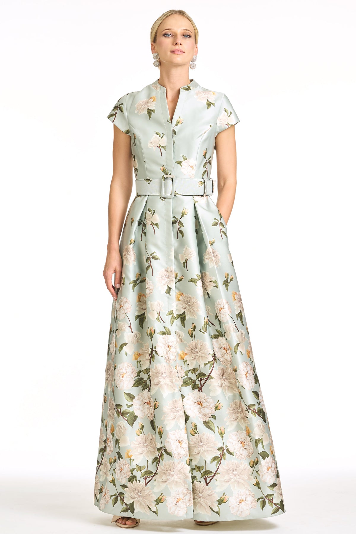 Front view of Marta Gown in Celadon Sweetbriar Degrade showcasing fitted bodice, belted waist, cap sleeves, and full floral skirt on white background