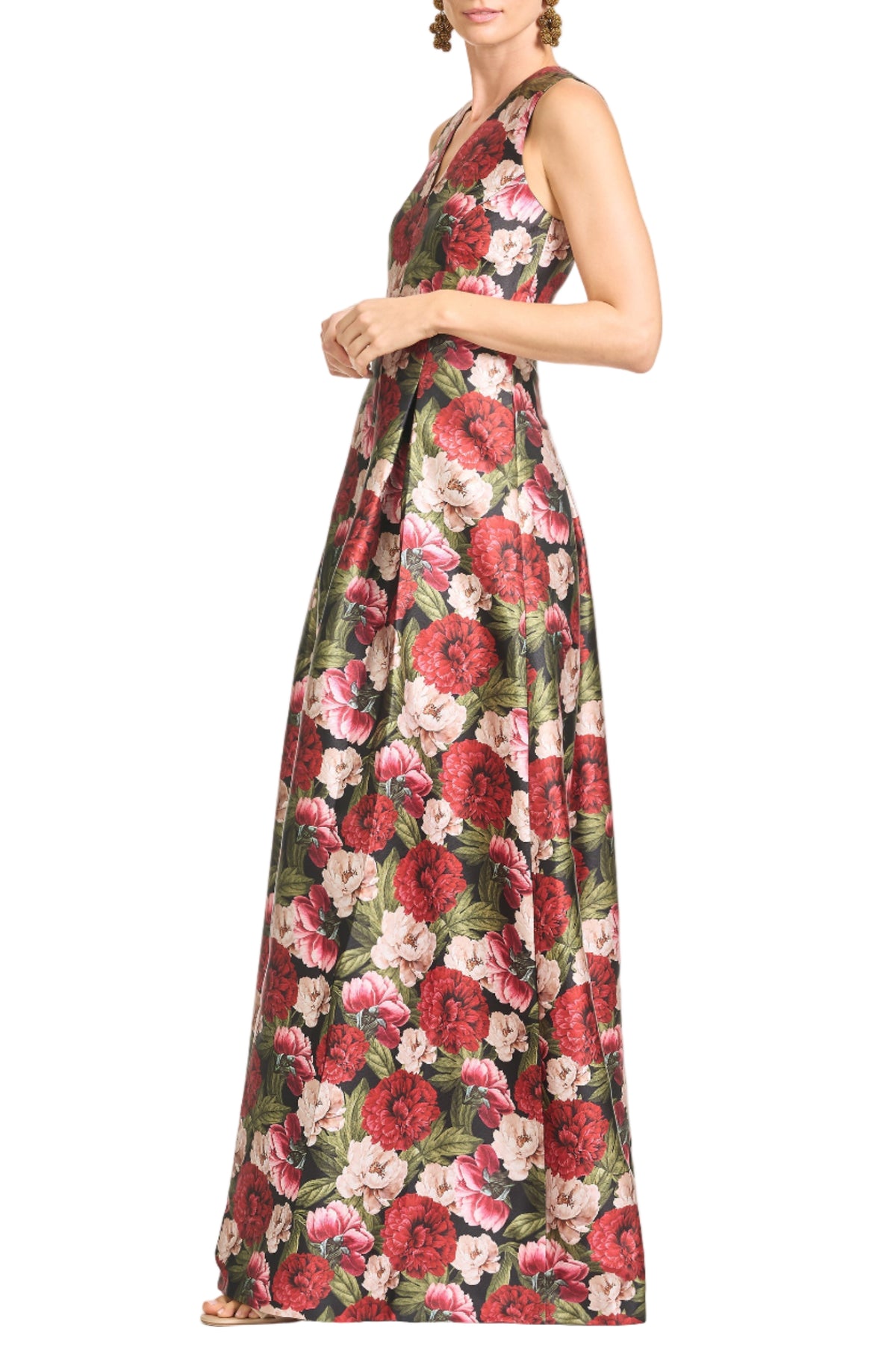 Three-quarter view of Brooklynne Gown in Peony Embers showcasing its floral print and flowing skirt with a white background