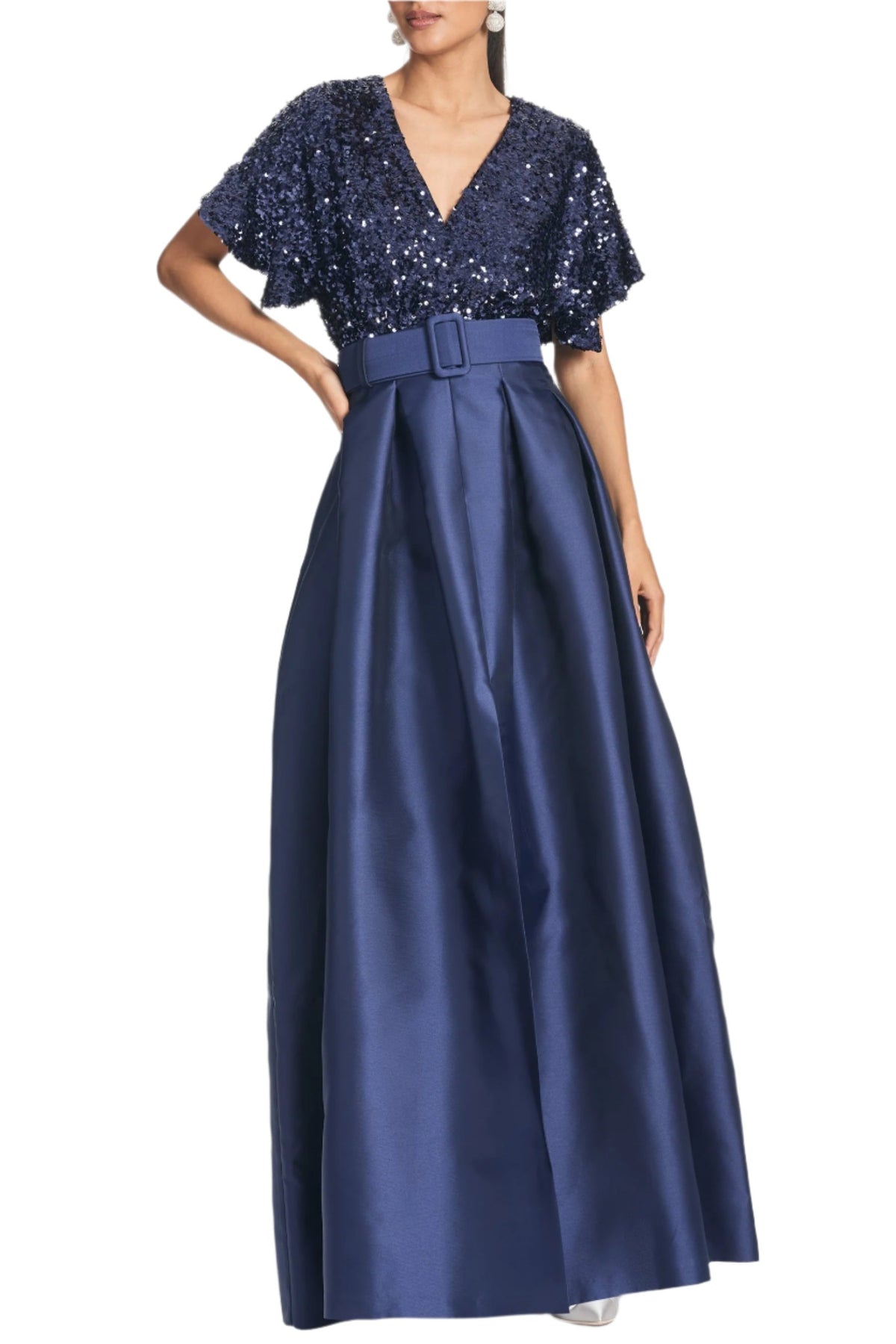 Front view of Simone Gown in Night Sky showcasing V-neck sequin bodice, self-belt, and pleated Mikado ball skirt on white