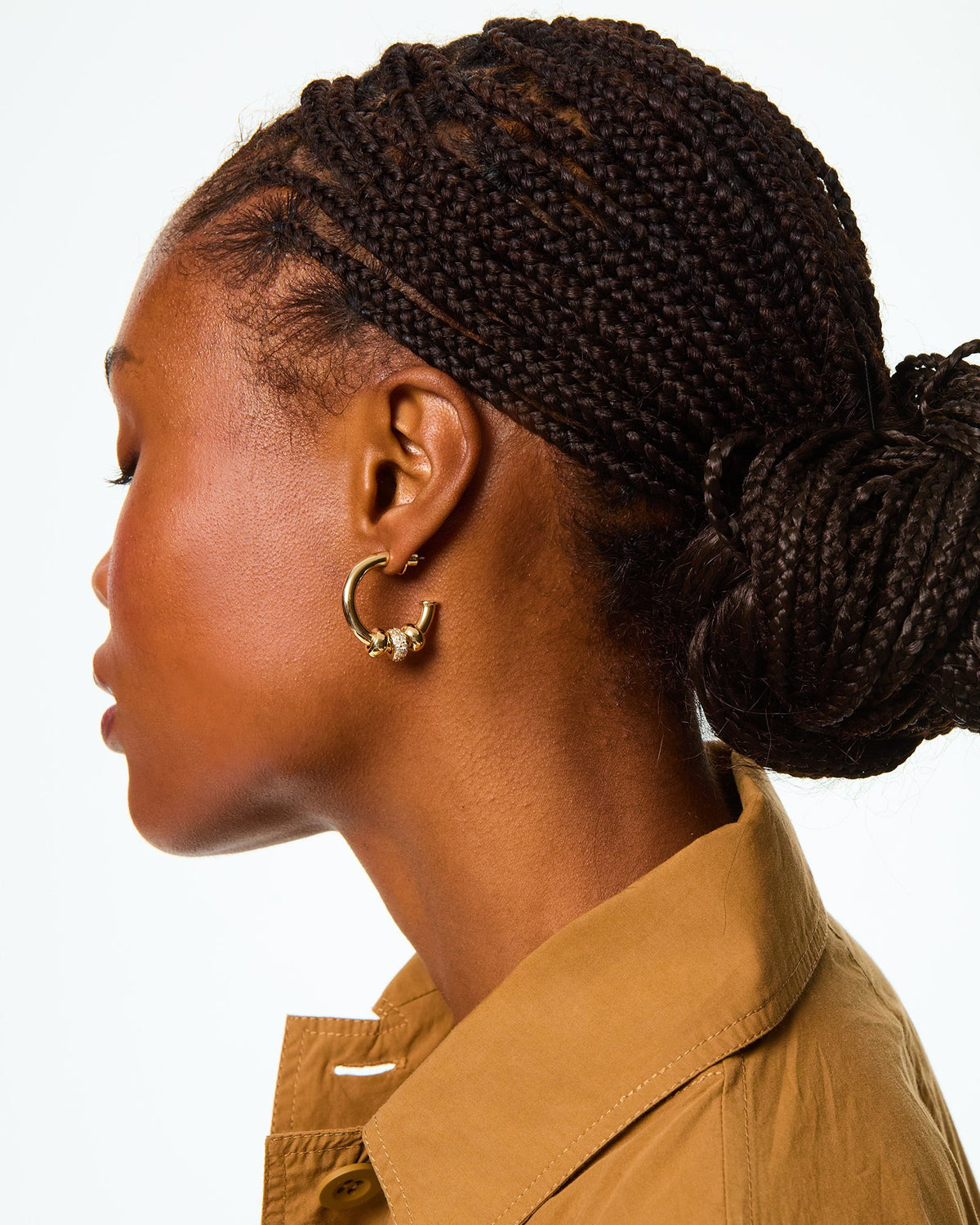 Close-up side view of The Pave Slider Hoop Earring showcasing pavé and gold tone slider charms on a model