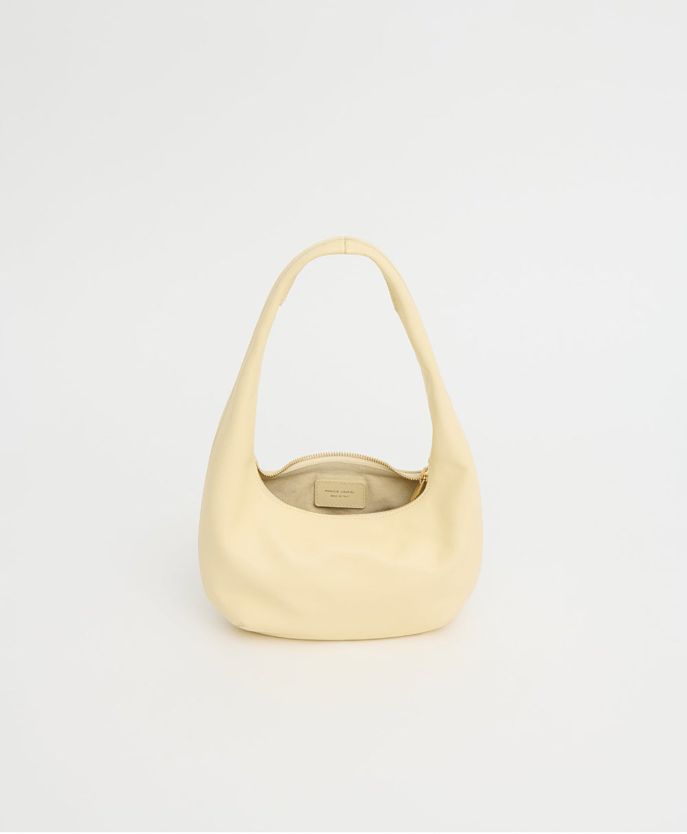 Front view of Mini Gnocchi Bag in crema showing slouchy rounded silhouette, zip-top and shoulder strap on white background