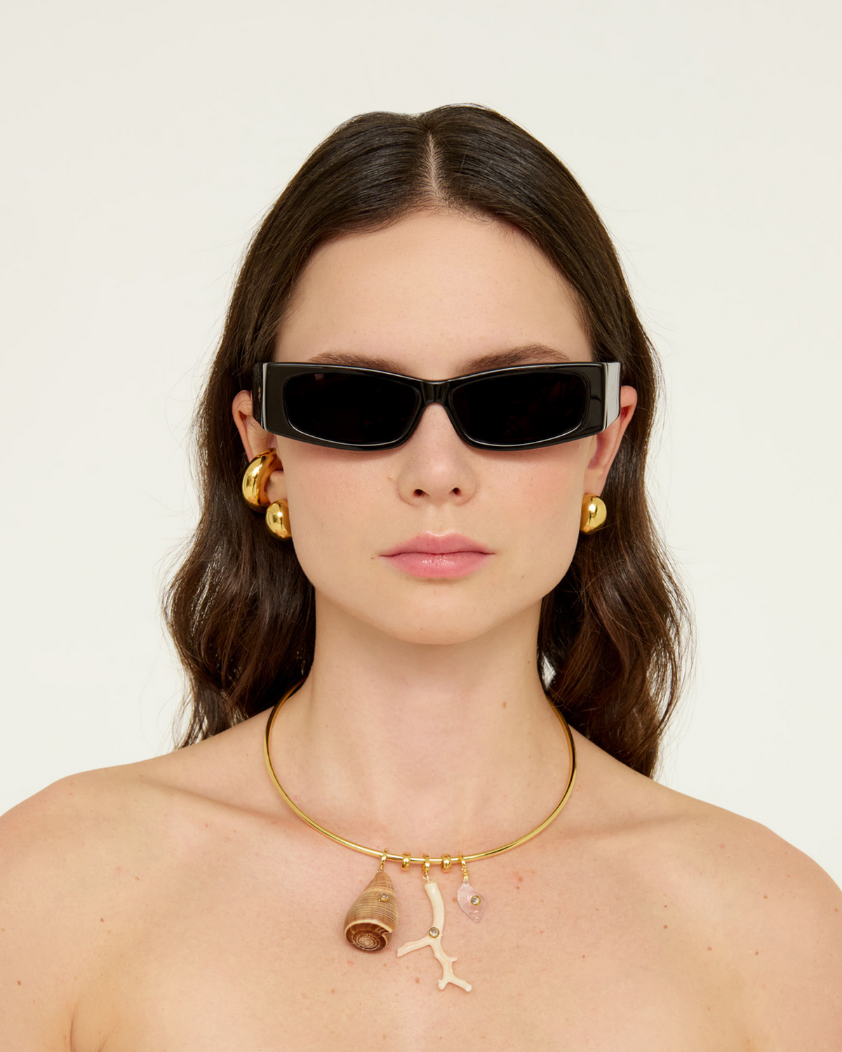 Front view of Briny Necklace on model showcasing 18k gold-plated wire with shell and resin detachable pendants and CZ accents