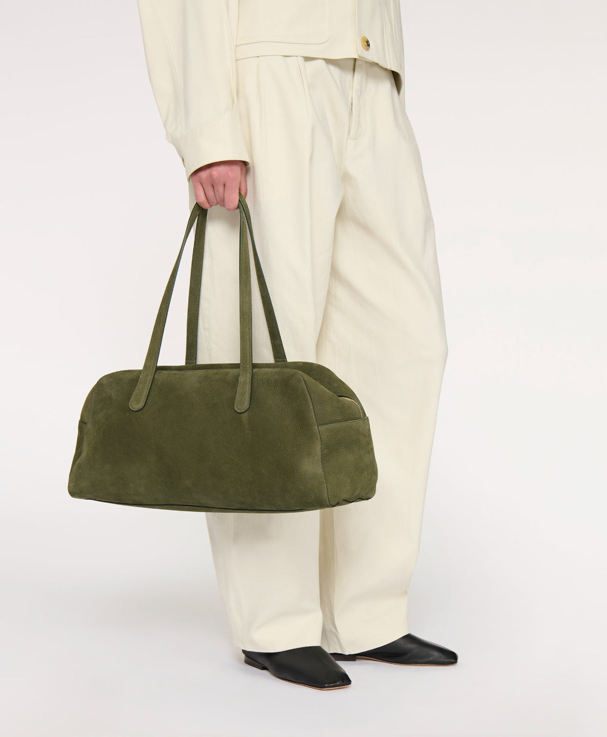 Front view of Large Helios suede tote in algae showcasing elongated east–west silhouette and shoulder straps against a white background