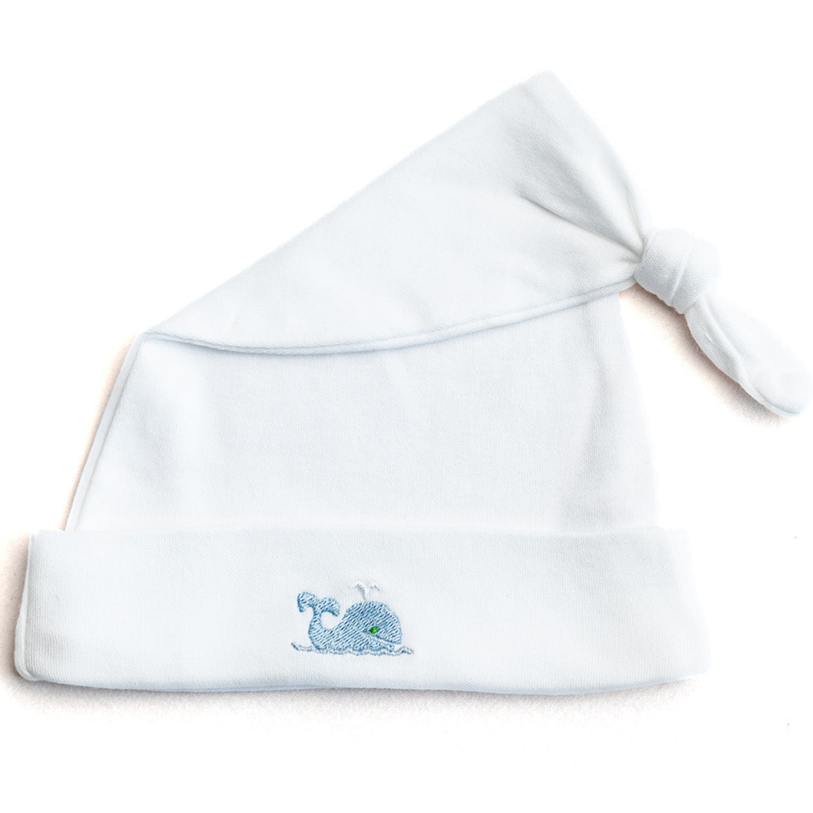 White baby hat with blue embroidery on a white background
