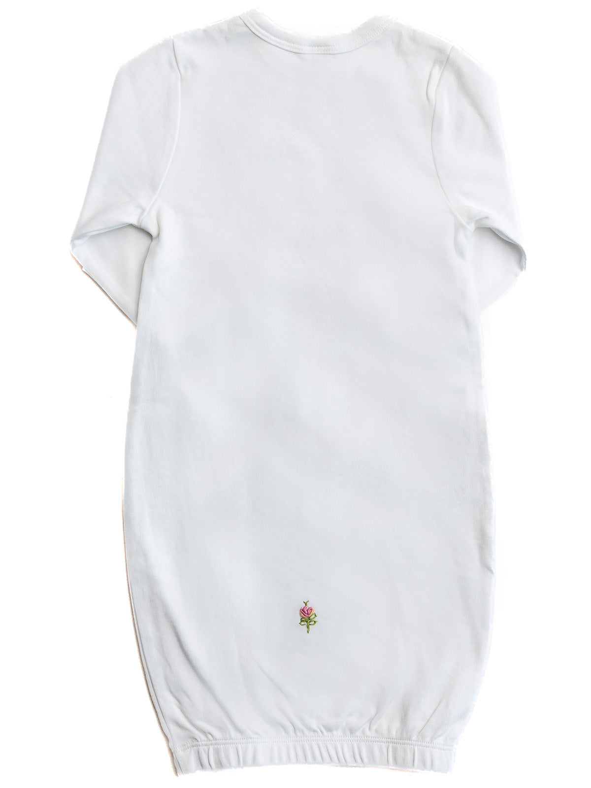 White baby gown with a small embroidered design on a white background