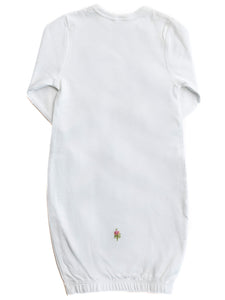 White baby gown with a small embroidered design on a white background