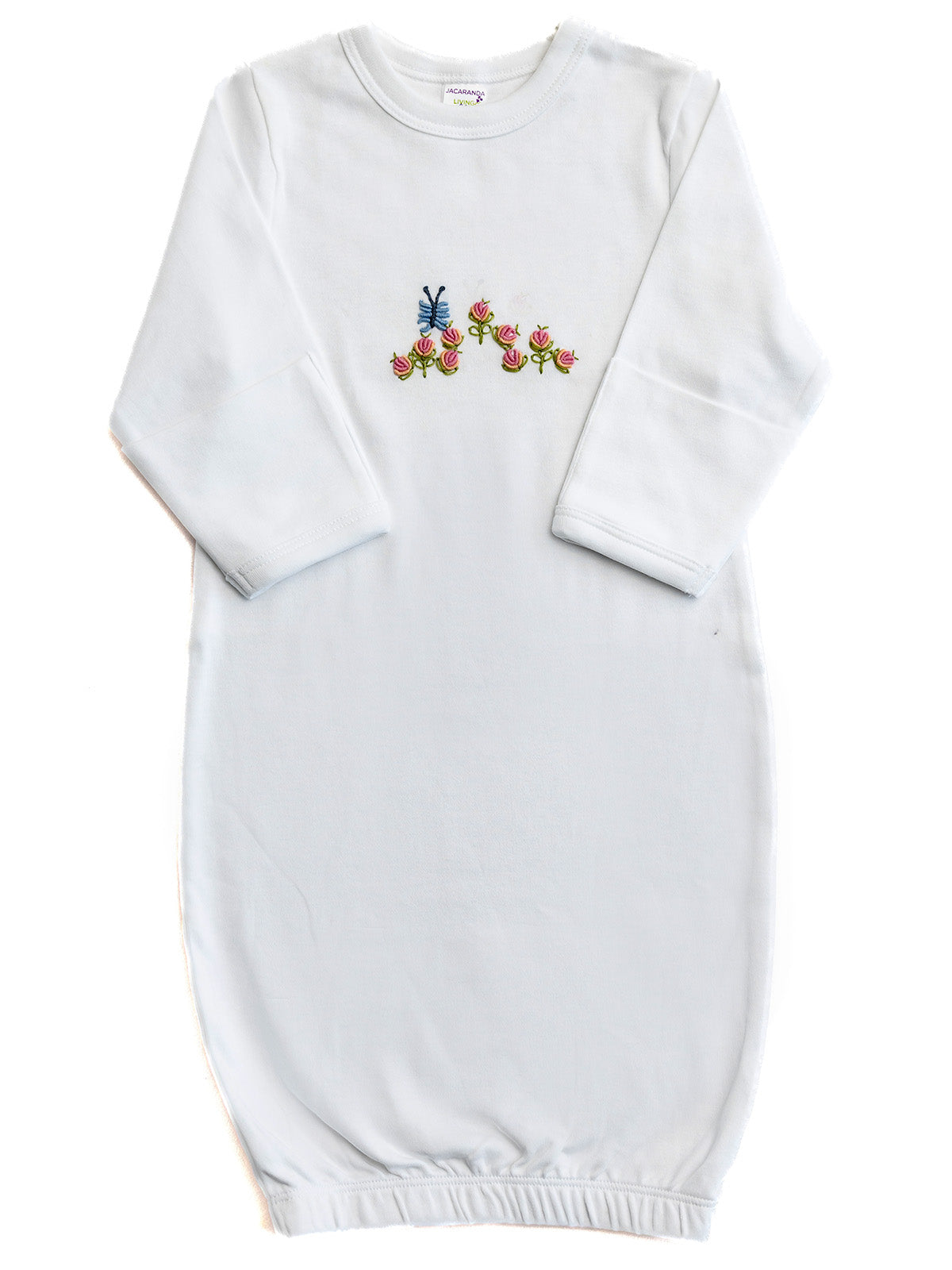 White baby gown with colorful floral embroidery on a white background
