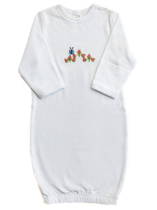 White baby gown with colorful floral embroidery on a white background