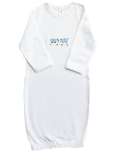White baby gown with floral embroidery on a white background