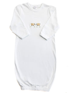 White baby gown with lion embroidery on a white background