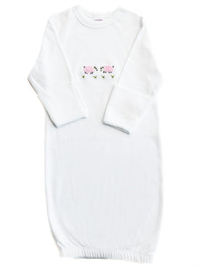 White baby swaddle with pink floral design on a white background