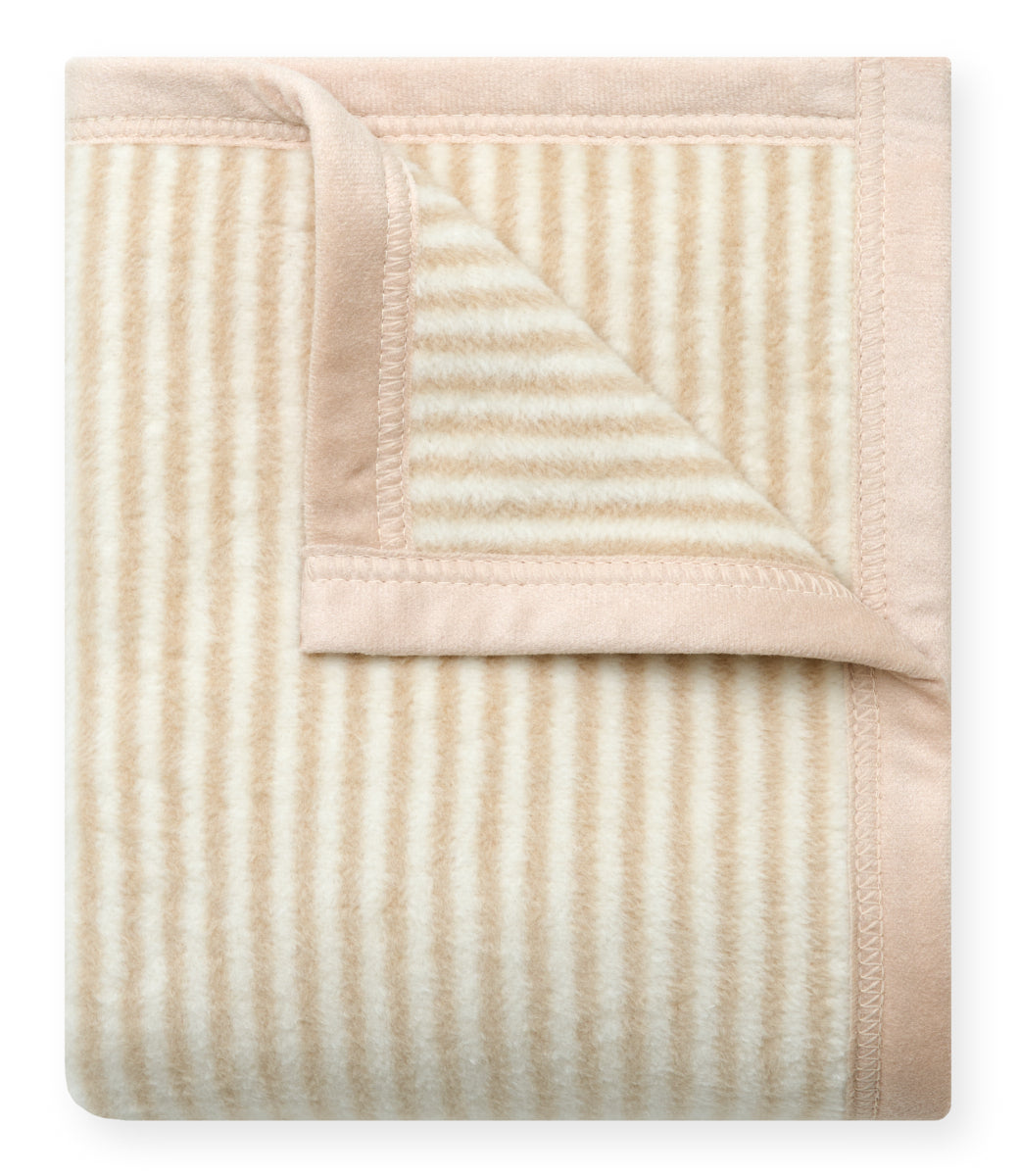 Folded mini blanket with tan and cream vertical stripes and solid tan border.