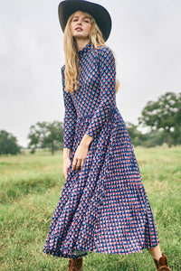The Sabine Dress has a turtleneck top, a fitted bodice, a pleated skirt in a stretch jersey.