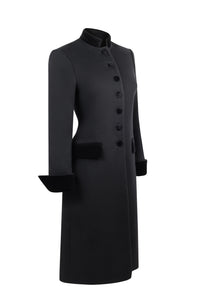 Three-quarter view of Safi Coat in Black showcasing tailored fit, velvet collar and pocket detailing with a white background