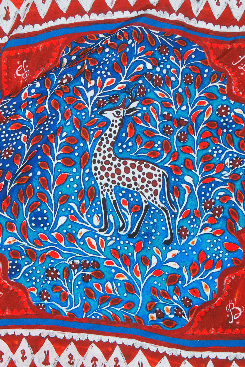 Double-sided printed scarf showcasing a whimsical winter tableau with a charming fawn at the center.